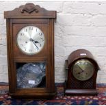 AN EDWARDIAN MAHOGANY CLOCK with domed case, silver dial with Arabic numerals, the movement striking