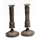 A PAIR OF 19TH CENTURY BRONZE CANDLESTICKS of column form, the stems decorated with geometric