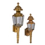 A BRASS SIX-GLASS COACHING TYPE LANTERN with spun top and scrolling bracket support, 77cm high