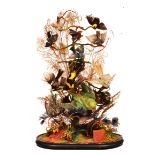 A VICTORIAN CASE OF PRESERVED EXOTIC BIRDS set within a naturalistic setting, all housed within a