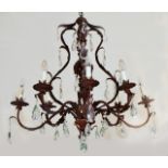 A FRENCH STYLE SEVEN-LIGHT BRONZED CHANDELIER with scrolling acanthus leaf arms and hung with tear