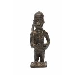 A SMALL BENNIN BRONZE SCULPTURE OF A SOLDIER carrying a gun across his shoulder, 14cm high