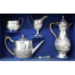 A GEORGE III OVAL SILVER TEAPOT with scroll handle, gadrooned body and pineapple finial, marks