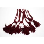 TWO PAIRS OF BURGUNDY BRAIDED CURTAIN TIE BACKS with tasseled ends