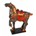 A CARVED WOODEN POLYCHROME DECORATED ORIENTAL SCULPTURE OF A HORSE with one foot raised, the blue