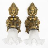 A PAIR OF ART NOUVEAU BRASS WALL LIGHTS with white mask scrolling acanthus leaf back plates and