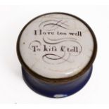 A GEORGE III CIRCULAR ENAMEL PATCH BOX with lid inscribed 'I Love Too Well To Kiss & Tell', with a