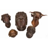 A GROUP OF FOUR ANTIQUE CARVED ELEMENTS, two cherubs heads, a rams head, a further head and 20th