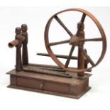 A GEORGE III MAHOGANY TABLE TOP SPINNING WHEEL, the wheel with turned spokes and mounted on a box