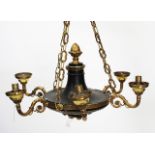 A SIX LIGHT EMPIRE STYLE HANGING LIGHT FITTING painted black with gilt metal mounts and scrolling