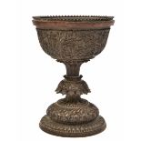 AN ANTIQUE, POSSIBLY BURMESE, HARDWOOD CUP with detailed carved foliate decoration, 18cm in height