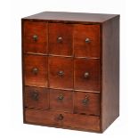 A GEORGIAN MAHOGANY TABLE TOP CHEST of nine short deep drawers above one long drawer, all with brass