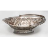 A GEORGE III OVAL SILVER BASKET with reeded hinged handle and border, later chased and engraved