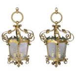 A PAIR OF BRASS HANGING GOTHIC REVIVAL HEXAGONAL LANTERNS with scrolling supports, 79cm high