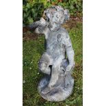 AN ANTIQUE LEAD FIGURE OF A BACCHANALIAN BOY with vine leaf wreath on his head and seated on a