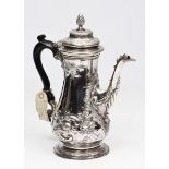 A GEORGE III SILVER COFFEE POT of baluster form, having a stepped cover with pineapple finial, the