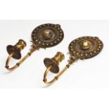A PAIR OF GILT METAL CANDLE WALL LIGHTS possibly Indian, with a filigree roundel with central