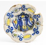 A SMALL LATE 17TH CENTURY MOULDED DUTCH DELFTWARE DISH, painted in blue, yellow and green with a