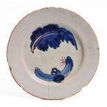 AN 18TH CENTURY DELFTWARE PLATE decorated with an abstract design of a leaf and rockwork, 19.2cm