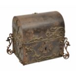 AN ANTIQUE DOME TOPPED IRON CASKET with applied scrolling decoration, 16cm wide