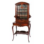 AN EDWARDIAN ROSEWOOD CABINET ON STAND with arching top and decorative inlay to the glazed door