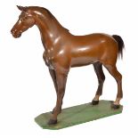 A LATE 19TH/EARLY 20TH CENTURY CARVED AND PAINTED PINE SADDLERS MODEL OF A HORSE with articulated