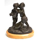 A 19TH CENTURY FRENCH BRONZE GROUP OF TWO STANDING PUTTI AND A SEATED YOUNG FAUN, mounted on an oval