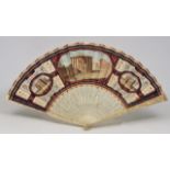 AN EARLY 19TH CENTURY LADIES FAN with pierced and carved ivory sticks, the central decoration of