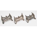 THREE LATE VICTORIAN SILVER MENU HOLDERS BY WILLIAM COMYNS each with pierced scrolling decoration