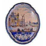 A 19TH CENTURY DUTCH DELFT POLYCHROME WALL PLAQUE decorated with a coastal river scene with