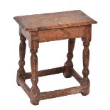 AN 18TH CENTURY OAK JOINT STOOL of pegged construction, the rectangular seat and turned legs