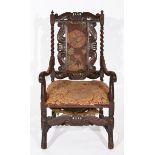 A 19TH CENTURY CAROLEAN STYLE MAHOGANY OPEN ARMCHAIR, with spindle supports and carved crown and