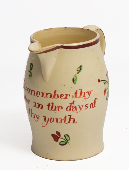 A LATE 18TH/EARLY 19TH CENTURY ENGLISH CREAMWARE JUG, with a loop handle and hand painted floral