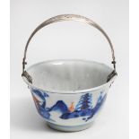 AN 18TH CENTURY CHINESE PORCELAIN TEA BOWL decorated in blue with an Oriental landscape with iron