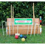 A JAQUES CROQUET SET contained within a pine box, the box 110.5cm wide