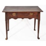 AN 18TH CENTURY  OAK LOWBOY with a single frieze drawer and brass handles with shaped frieze and