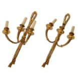 A PAIR OF ANTIQUE GILT METAL HANGING WALL LIGHTS with ribbon tied decoration and tassel finials,