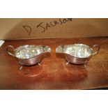 A PAIR OF MAPPARD AND WEBB SAUCE BOATS with shaped tops and 'c' scroll handle and standing on