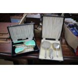 A SILVER FOUR PIECE DRESSING TABLE SET consisting of hand mirror, two brushes and a comb, each