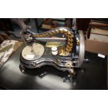 A LATE 19TH/EARLY 20TH CENTURY JONES & COMPANY TABLE TOP SEWING MACHINE, decorated all over with