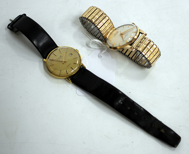 AN ACCURIST 21 JEWEL ANTI-MAGNETIC 9 CARET GOLD CASE WATCH with silvered dial, 3cm diameter together