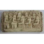 AN ANTIQUE BONE SNUFF BOX, the lid, back and sides carved with various figures in low relief (AF)
