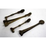 FOUR VARIOUS ANTIQUE PASTRY JIGGERS, the largest 14.2cm long (4)