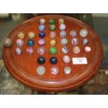 A TURNED MAHOGANY BAGATELLE BOARD complete with a selection of various 19th century and later