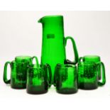 AN EMERALD GREEN GLASS ALE SET, possibly Whitefriars, with bubble inclusions with a jug and six half