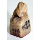 AN ANTIQUE CHINESE SOAPSTONE SEAL mounted by a rabbit with various script, 3.5cm high