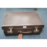 AN OLD SUITCASE containing a number of watch makers parts and tools, wire etc.