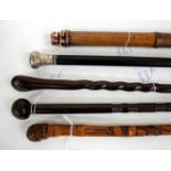 AN EARLY 20TH CENTURY WEIGHTED BAMBOO CANE 87cm in length, a further Eastern carved bamboo cane plus