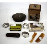 A WHITE METAL CIGARETTE CASE, three white metal napkin rings, a horn snuff box, an amber cheroot
