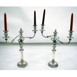 A PAIR OF SILVER PLATED TWO BRANCH CANDELABRA with gadrooned drip pans, reeded arms, central